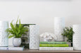 white porcelain lamps styled on shelf with books and greenery hamptons coastal lighting decor
