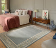 Sanderson Linnean Porcelain Rug styled in bedroom with geometric border design