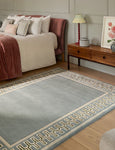 Sanderson Linnean Porcelain Rug styled in bedroom with geometric border design