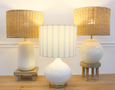 Bayville Lamp with rounded white glass base, gold detailing, and striped blue and white linen shade.