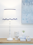 Brunswick Lamp White with scalloped linen shade and tall white polyresin base.
