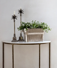 Large rectangular silver planter with rounded handles, crafted from aluminium with a vintage finish, styled on a console table with greenery and decorative candle holders.