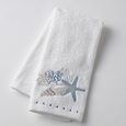 Seaside Hand Towel in soft white cotton with embroidered seashell, coral, and starfish motif.