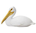 Seated pelican decorative sculpture in white polyresin with elongated beak, styled on a console table