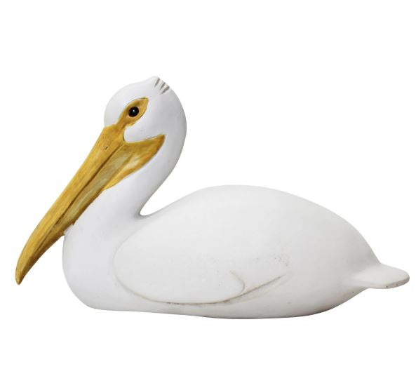 Seated pelican decorative sculpture in white polyresin with elongated beak, styled on a console table