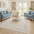 Serenity Ivory Textured Rug with soft distressed ivory and beige pattern and subtle blue accents.