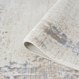 Serenity Ivory Textured Rug with soft distressed ivory and beige pattern and subtle blue accents.