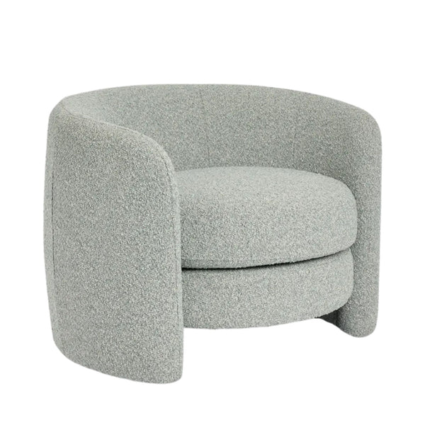 Soft blue curved armchair with sculptural silhouette and upholstered finish