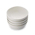 Set of four white Sophie Conran noodle bowls with signature ripple texture stacked together