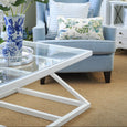 Southampton white coffee table styled in a coastal living room with blue armchair and glass top detail