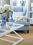 Southampton white coffee table styled in a coastal living room with blue armchair and glass top detail