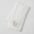 Set of three white cotton Christmas hand towels with champagne-gold embroidered motifs including presents, snow globe, and ‘JOY’ design.