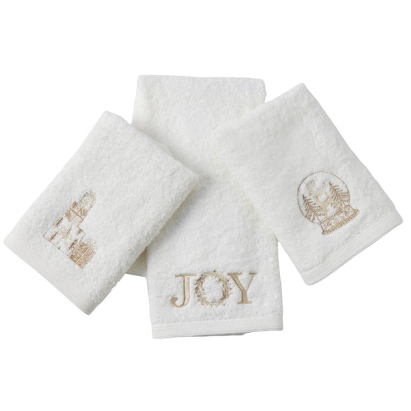 Set of three white cotton Christmas hand towels with champagne-gold embroidered motifs including presents, snow globe, and ‘JOY’ design.