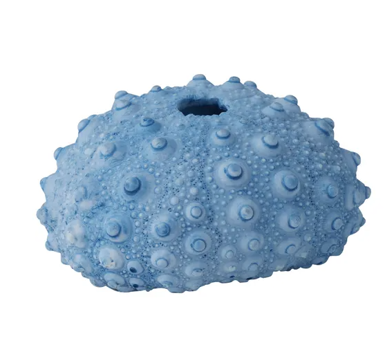 A small, decorative object made of blue resin, shaped like a flattened sea urchin or coral formation. The surface is covered in numerous small, rounded bumps, and there is a hole at the top. The colour is a mix of light and dark muted blues.