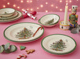 Spode Christmas Tree 12 piece dinner set with festive green rim plates and bowls stacked together