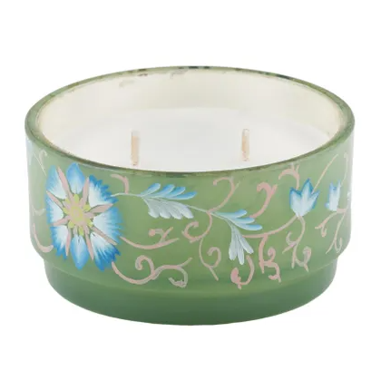 Green floral glass candle jar with blue blossom detailing and dual wicks, decorative home fragrance accessory.
