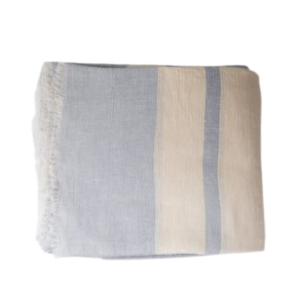 Pale blue and ecru striped linen tablecloth with softly frayed edges styled on a Hamptons-style dining table