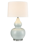 Light blue ceramic table lamp with white shade on white background