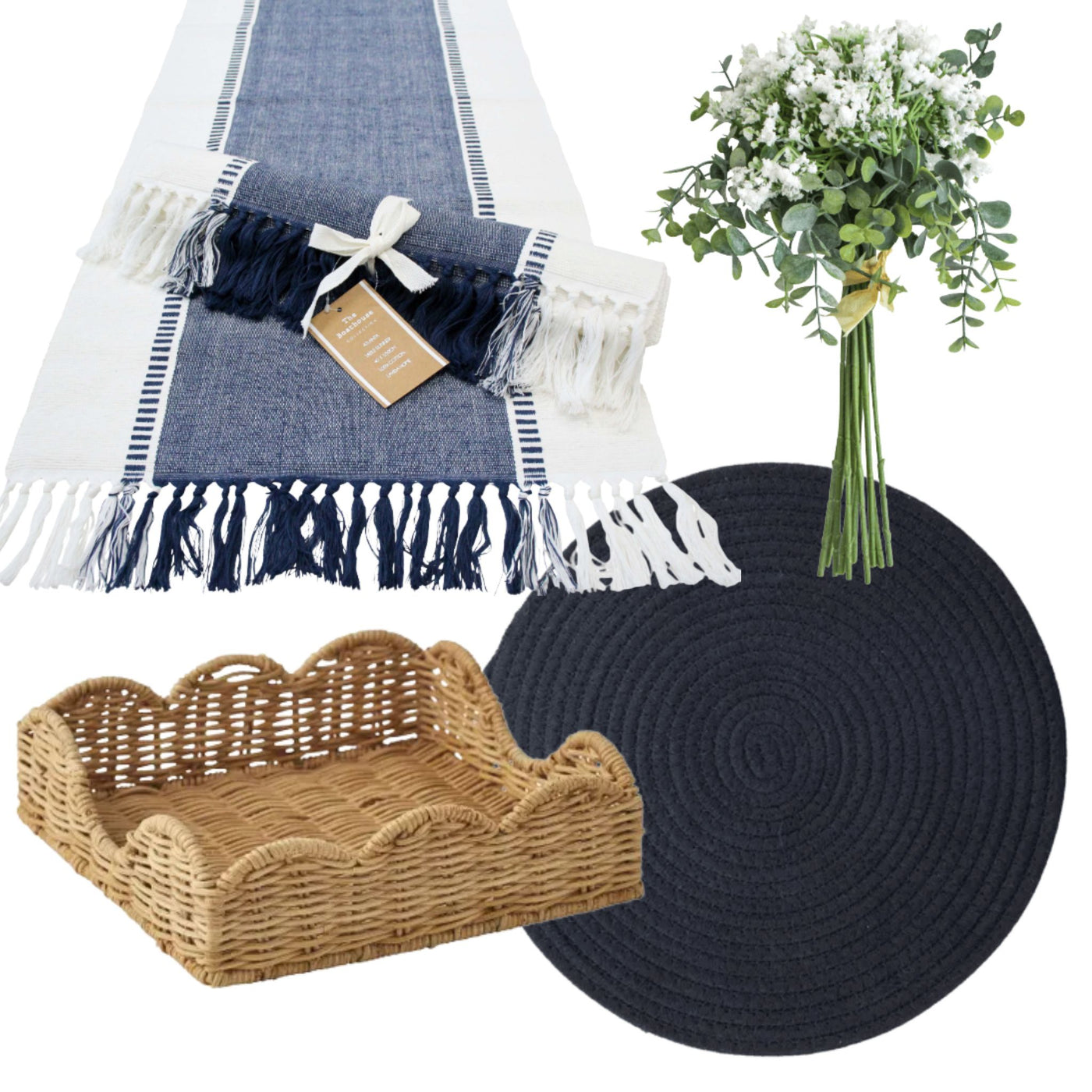 Coastal dining table styling bundle featuring a navy and white fringed table runner, navy round woven placemats, a rattan napkin holder, and a eucalyptus with baby’s breath faux floral bunch styled in a relaxed Hamptons-inspired palette.