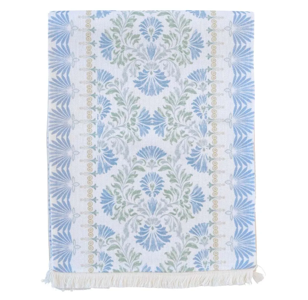 Vintage patterned table runner in soft blue and green tones with fringed edges.