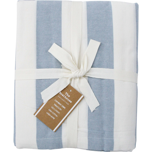 A tablecloth folded neatly, showing a wide vertical stripe pattern in alternating shades of light blue and white. The fabric has a relaxed, slightly textured finish. The tablecloth is tied with a white ribbon and has a brown product tag.