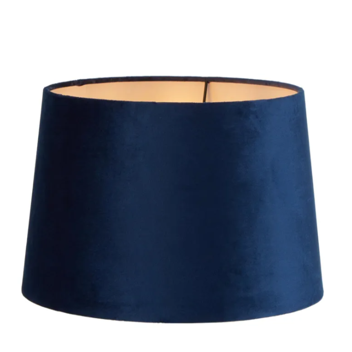 Royal blue velvet drum lamp shade showing soft texture and warm interior lining