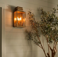 Antique brass outdoor wall light mounted beside exterior wall