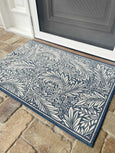 Willow blue non-slip door mat 60x90cm with white botanical leaf pattern on timber floor at front door