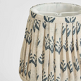 Close up of pleated linen lamp shade with soft blue floral design