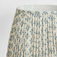 Close up of willow blue pleated lamp shade showing linen texture and pattern