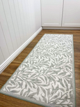 Willow Sage non-slip runner 60x150cm with sage botanical leaf pattern on white background placed on timber flooring