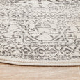 Addison Silver Round Rug showing distressed geometric pattern and bound edge