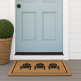 Coastal front entrance styled with a pale blue door and Adirondack coir mat in a Hamptons-inspired outdoor setting.