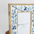 close up detail of blue floral bone inlay craftsmanship on Alaia photo frame
