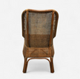 A natural brown rattan dining chair with a high, slightly curved backrest and armrests. The back and seat are both made from tightly woven rattan, and the chair has a classic, elegant silhouette.