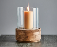 Close up of glass hurricane shade and dark natural wood base showing texture and finish