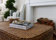 Decorative hurricane lamp styled on a console table adding soft candlelight to living room decor
