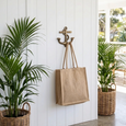 Anchor Brass Wall Hook featuring a classic nautical anchor design in solid brass on a white VJ wall with a bag hanging from it