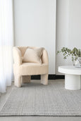 Arden Dove woven rug styled in a soft neutral living room with boucle chair and white table