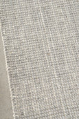 Corner detail of Arden Dove woven rug showing structured grid texture