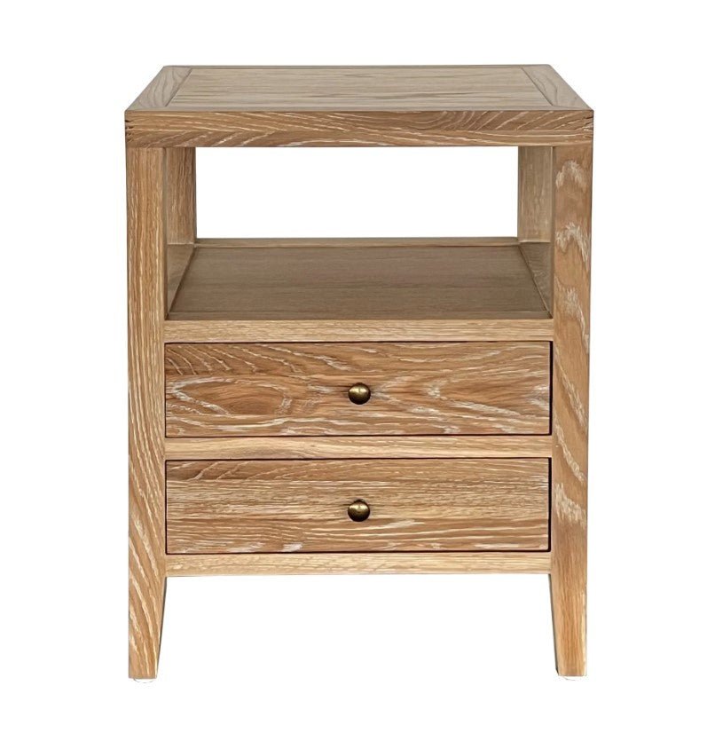Arden Whitewash Oak Side Table featuring two dovetailed drawers, brass knobs and an open storage shelf.