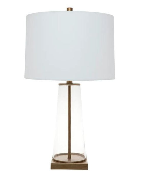 Arlo glass table lamp featuring clear glass body, antique gold detailing and off white linen shade.