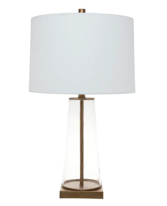 Arlo glass table lamp featuring clear glass body, antique gold detailing and off white linen shade.