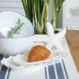 Ascott Navy Table Runner styled with white and blue tableware, white flowers and coastal decorative accents on a timber table.