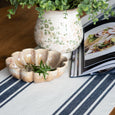 Ascott Navy Table Runner styled on a timber table with greenery, patterned ceramic vase and natural decorative bowl.