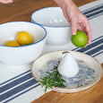 Ascott Navy Table Runner styled on a timber kitchen table with white and blue bowls, citrus and blue and white ceramics.