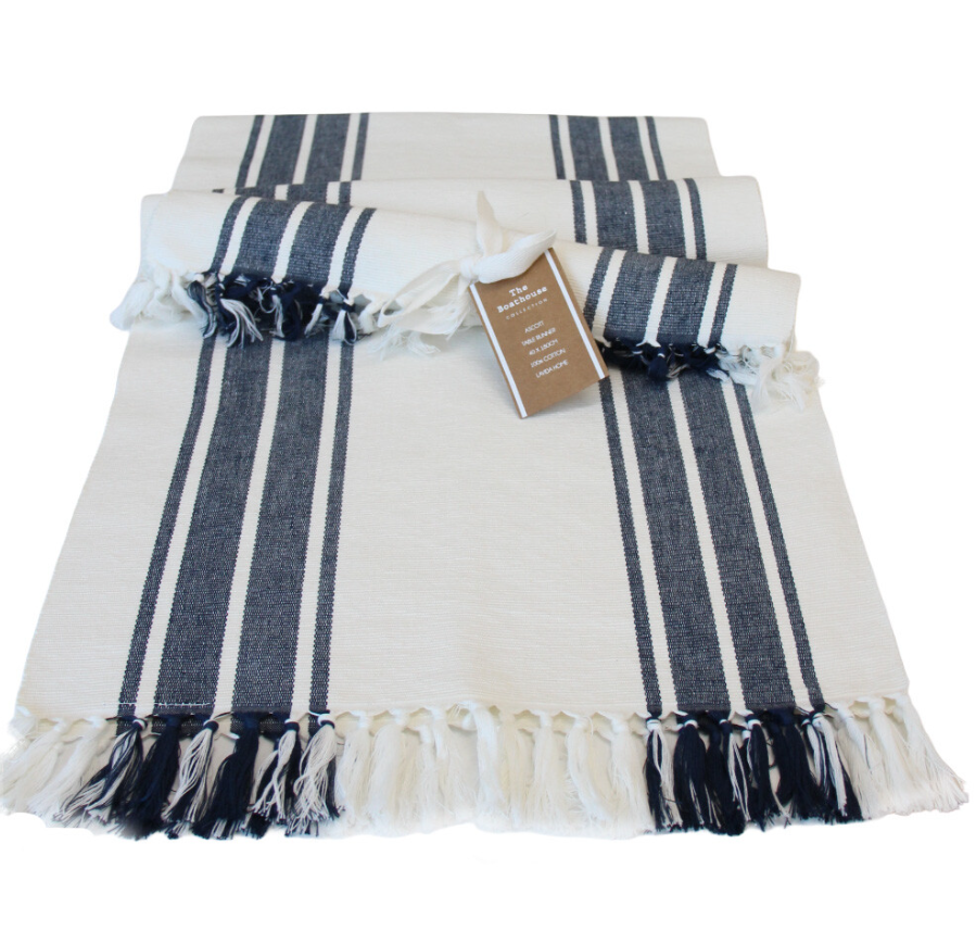 Navy striped cotton table runner with fringe edges styled flat and rolled