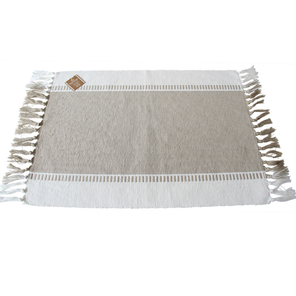 Natural cotton placemat with decorative woven detailing and tassel edging, ideal for Hamptons and coastal table styling.