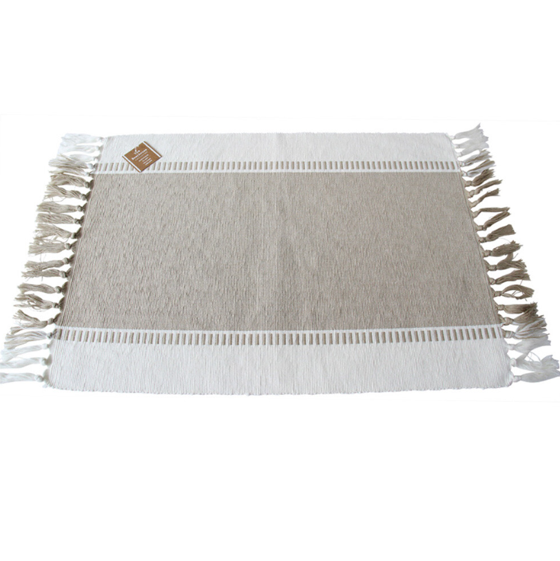 Natural cotton placemat with decorative woven detailing and tassel edging, ideal for Hamptons and coastal table styling.