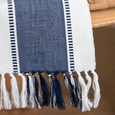 Close-up of Atlanta Navy Table Runner showing navy stonewashed cotton weave, white border and navy and white tasselled fringe.